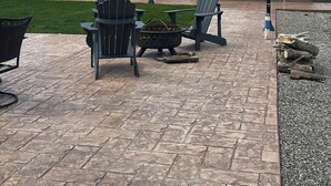 A patio area with Adirondack chairs, a fire pit, and a small building with a red roof and a beige one. - Cabin 3 with AC and WiFi in charming Reed Point. ADA compliant. (Reed Point)