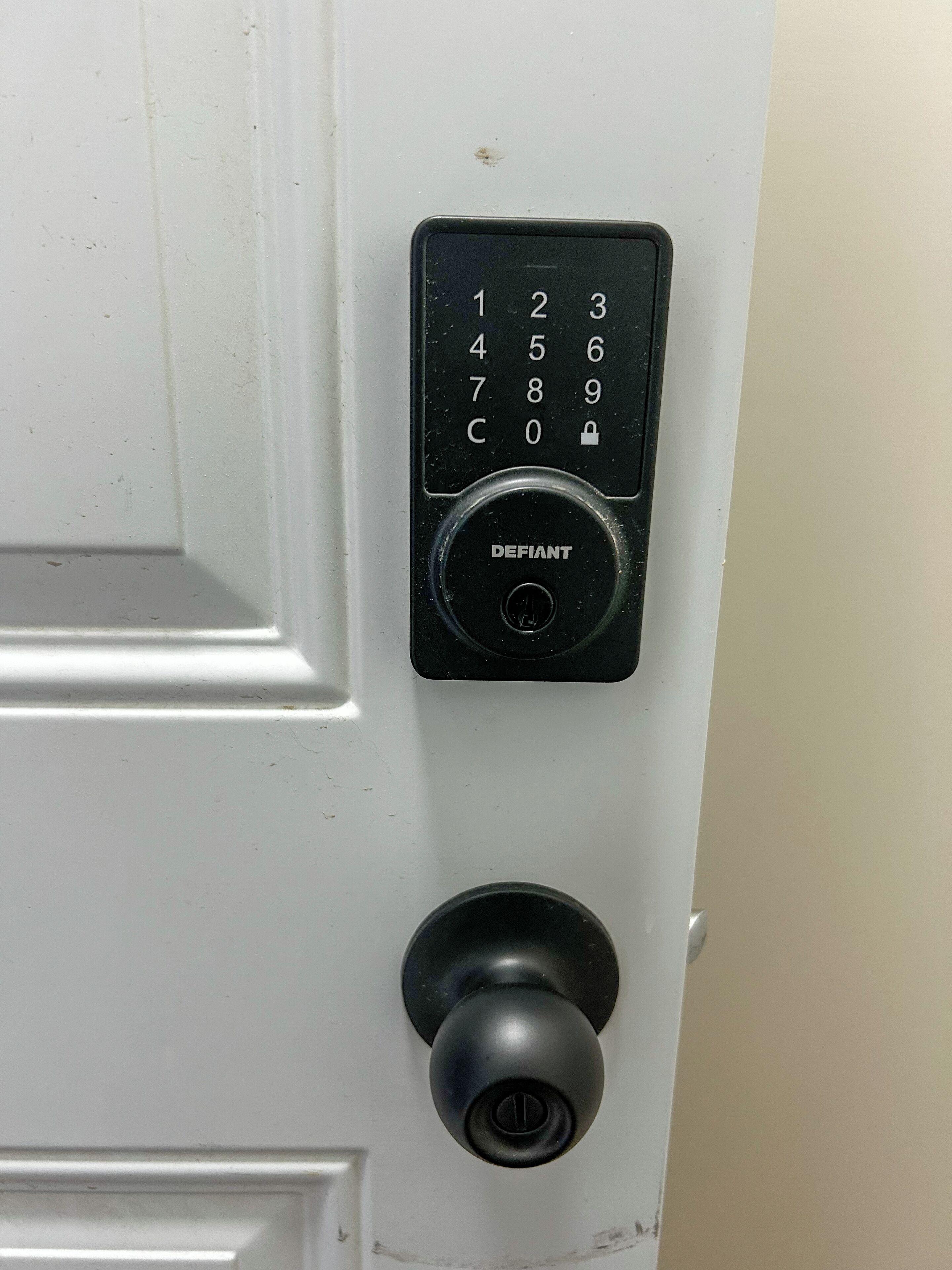 A door with a numeric keypad and a keyhole.