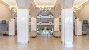 A spacious lobby with high ceilings, marble columns, and a central seating area. - Ocean front 2 bedroom Deluxe Suite at Villa Del Palmar Resort Cabo San Lucas (Cabo San Lucas)