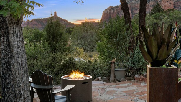 A patio with a fire pit, seating, and a view of a canyon. - Redscape, Near Great Hiking, Views, Hot Tub, Firepit-Charming Design (Sedona)