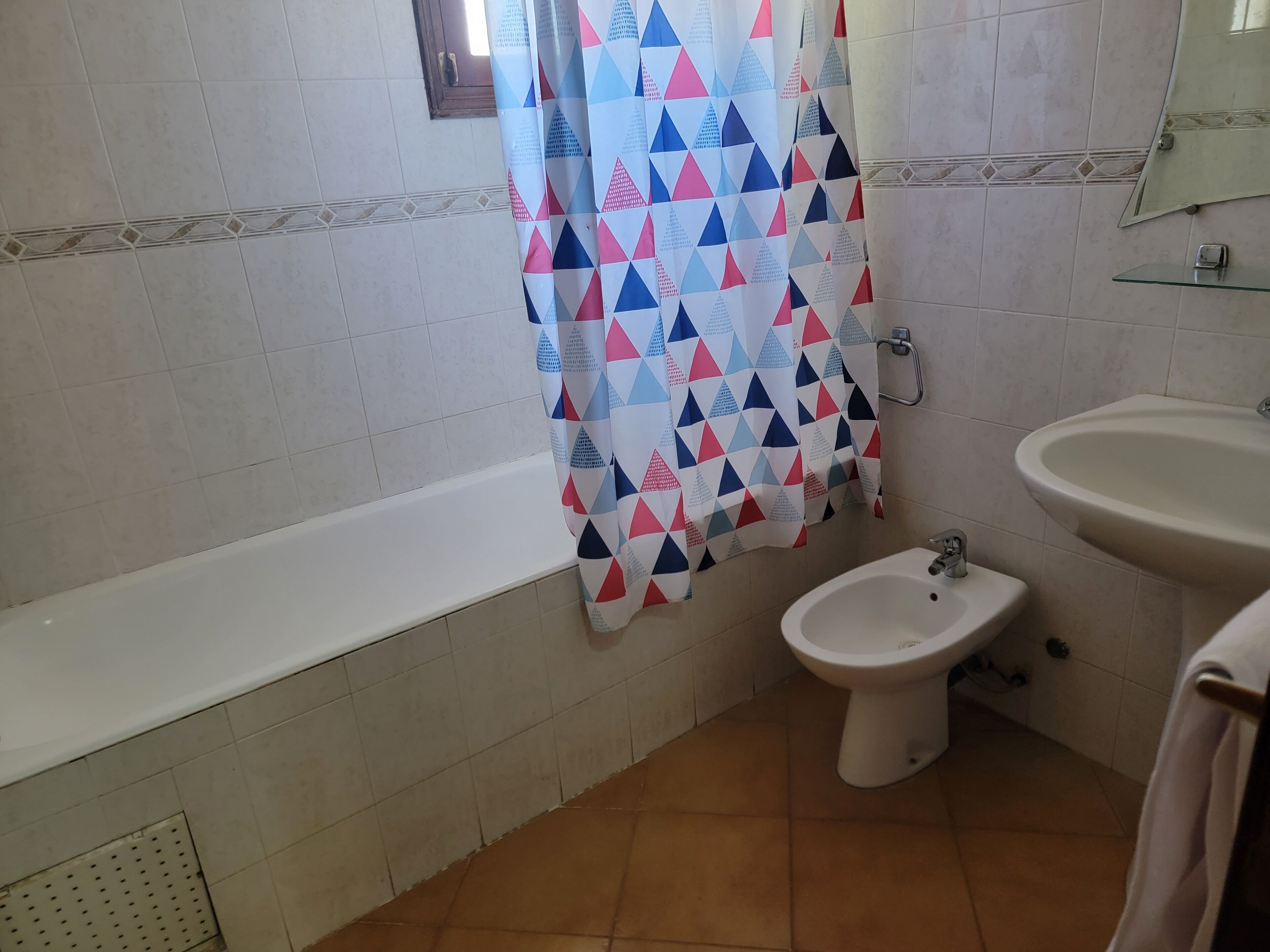 Ein Badezimmer mit einer Badewanne, einem Bidet und einem Waschbecken.