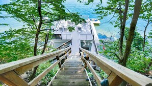 Un escalier en bois menant à une jetée d’où l’on peut admirer le paysage aquatique.