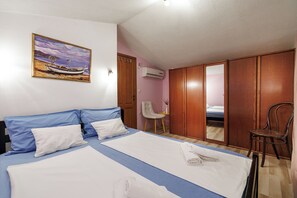 A bedroom with a bed, a chair, a wardrobe, and a painting on the wall. - Villa Ivona (Kvarner - Poljica) (Poljica)