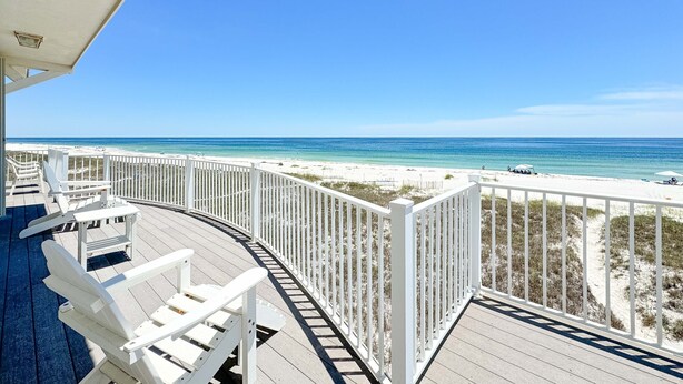 A deck with white chairs and a railing overlooking a beach. - LARGE PRIVATE HOME FOR THE PERFECT VACATION! (Gulf Shores)