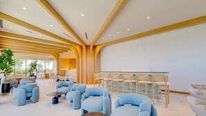 A spacious lobby with modern seating, a bar area, and large windows offering views. - Oceanview 2BR/2BA in Miami Beach + Beach Club 1408RP (Miami Beach)