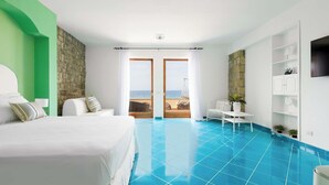 A hotel room with a bed, a seating area with a view of the sea, and a pool. - Case Marcia Mia - 2 adjacent seafront houses (San Montano)
