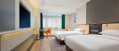 A hotel room with two beds, a desk, a chair, and a TV.