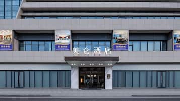 A hotel with a modern facade, large windows, and a prominent entrance.