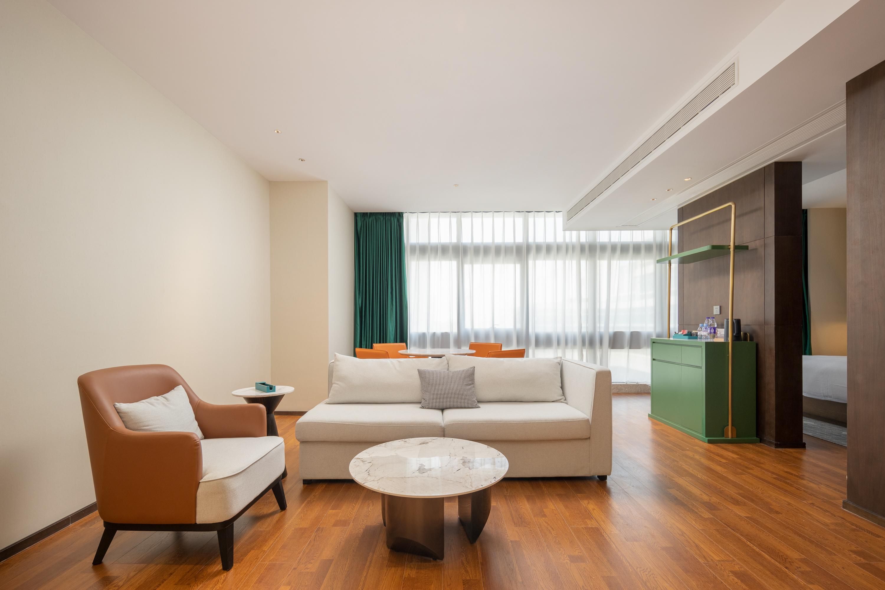 A modern living room with a sofa, armchair, and coffee table.