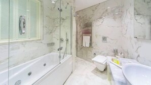 A modern bathroom with a glass-enclosed shower, a separate toilet, and a freestanding bathtub. - Hotel Morione & Spa Center (Istanbul)