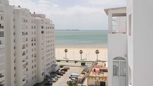 A high-rise building with a view of a beach and ocean.