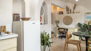 A kitchen with a white refrigerator, wooden cabinets, and a dining area with a table and chairs. - Vallarta's lovely apartment (Puerto Vallarta)