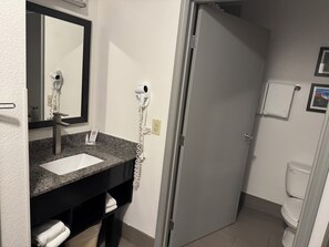 Een haardroger, handdoeken, zeep, toiletpapier