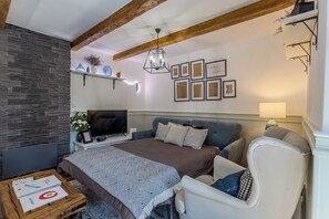 A bedroom with a bed, a TV, a desk, a chair, and a lamp. - BalChill House With Sauna And Jacuzzi, Balatonszepezd, Hungary (Balatonszepezd)