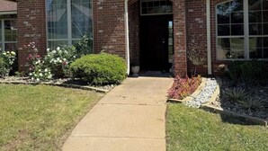 A brick house with a front entrance, a covered porch, and a well-maintained lawn. - Spacious 4BR Oasis with private pool perfect for families & Groups (Longview)