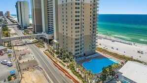 A high-rise hotel with a swimming pool, beachfront view, and adjacent road. - Tidewater 200 - Gorgeous Two Bedroom w/ Sunsets! (Panama City Beach)