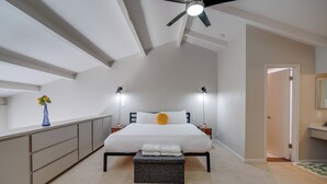 A bedroom with a bed, bedside tables, a ceiling fan, and a nightstand with a vase. - Vintage Stay, 1BR Old Town Scottsdale Retreat (Scottsdale)