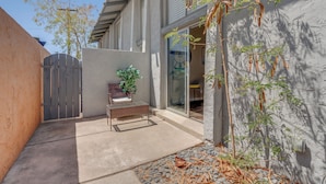 A modern house with a patio, a wooden gate, and a potted plant. - Vintage Stay, 1BR Old Town Scottsdale Retreat (Scottsdale)