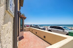 A parking area with a view of the beach and ocean.