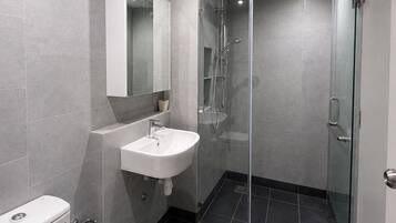 Shower, hair dryer, towels, toilet paper