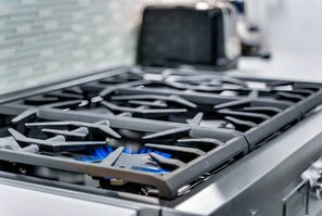 A gas stove with a blue flame.
