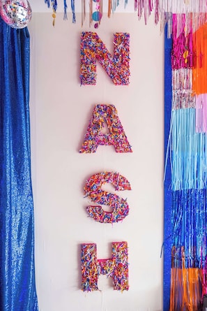A wall with letters made of colorful sprinkles.