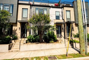 A row of modern townhouses with concrete steps and a small tree in the center. - Nashville house with rooftop deck, karaoke room & bunk room, sleeps 12 (Nashville)