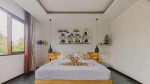 A hotel room with a large bed, a painting on the wall, and a window with curtains.