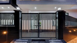 A gated entrance with a metal gate and steps leading up to a building. - The Byke Business Hotel - Sector 29 (Gurugram)