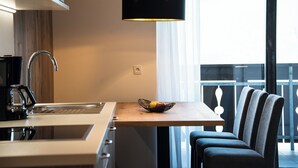 A modern kitchen with a sink, a coffee maker, and a fruit bowl on a wooden table. - Brixen-Plose! Your spacious family apartment directly in St. Andrä (Sankt Andrä)
