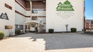 A modern hotel with a sign indicating it is Kurhotel Schluchsee, featuring amenities such as a sauna, medical center, and restaurant. - Holiday Apartment 'Loft Style' with Balcony and Wi-Fi (Schluchsee)