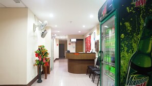 A hotel reception area with a Mountain Dew vending machine, a reception desk, and a plant decoration. - Hotel O Melintang Hotel (Hutan Melintang)