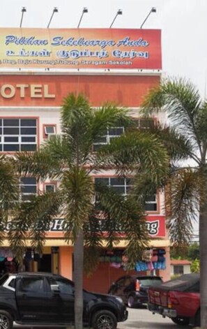 Un hotel con un cartel publicitario que anuncia 'Pilihan Sekelunga Andika & Lain Lain Lain Lain' y 'Hotel Andika'.