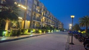 A multi-story hotel with balconies, a restaurant, and a bar/lounge area.