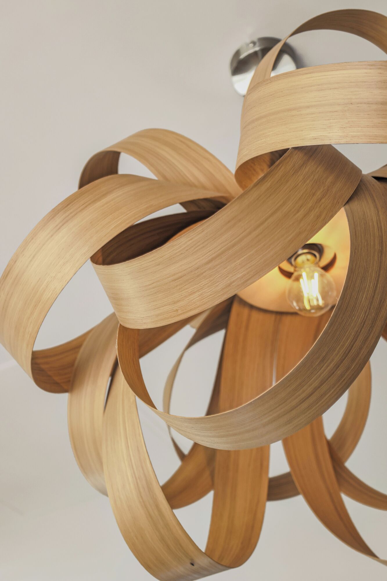 A modern pendant light fixture with a wooden design.