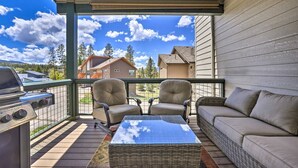 A balcony with a grill, two chairs, a sofa, and a table. - Peak Vistas | Walk to Trails | 4 Mins to Resort (Fraser)