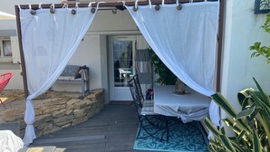 An outdoor seating area with a covered patio, stone wall, and potted plants. - NEW! VILLA LORANA Between sea and vineyards (SAINT CYR)