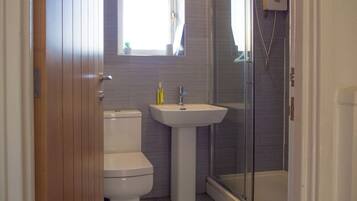 Shower, hair dryer, towels, toilet paper