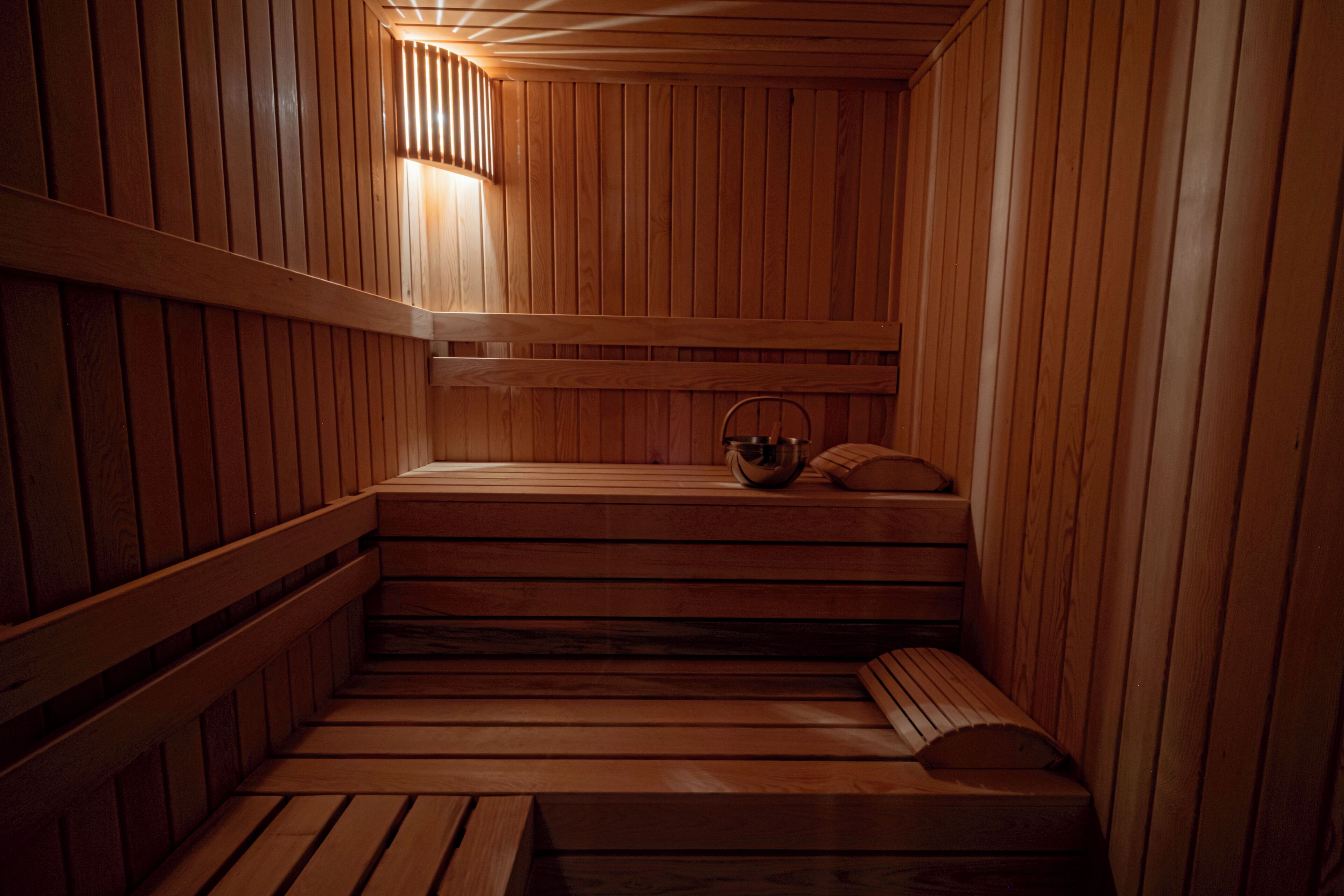 A wooden sauna with benches and a bench seat.
