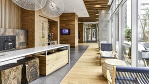 A modern kitchen with a wooden countertop, built-in appliances, and a large island. - Stylish 2BR Stay with Gym, Parking & Rooftop Views (Arlington)