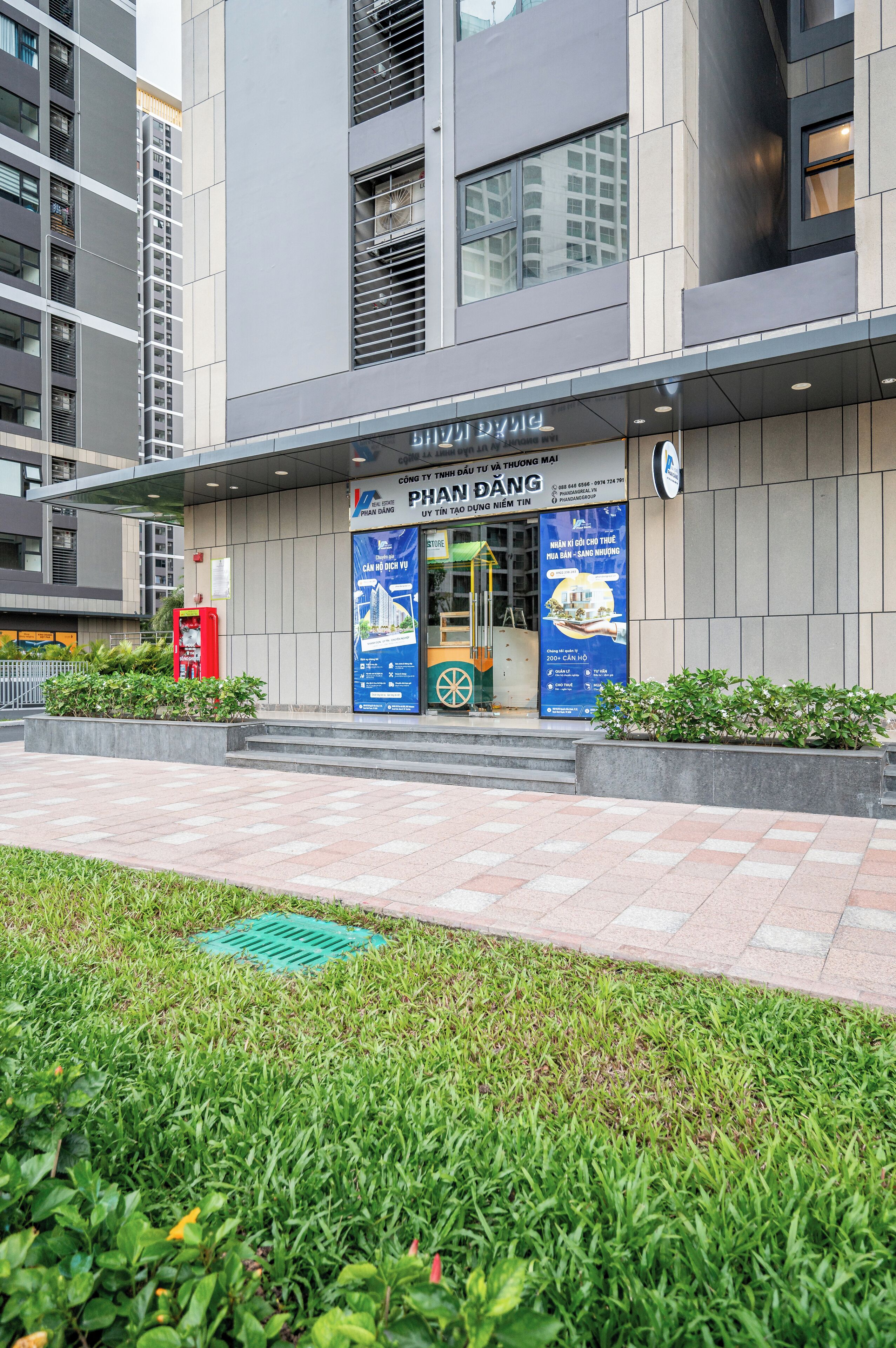 A modern building with a sign reading "PHAN DANG" and a blue advertisement.