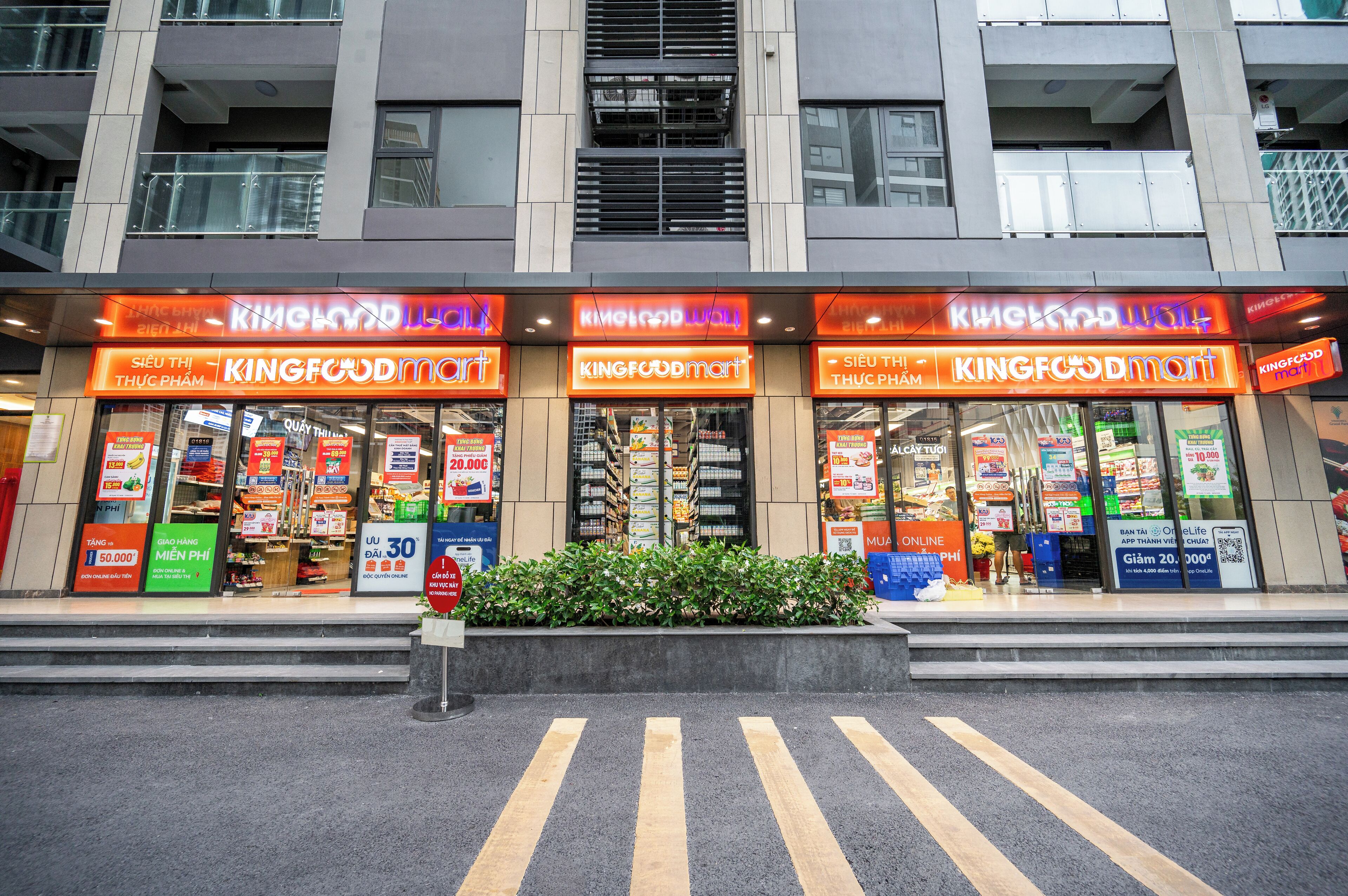 A KINGFOODmart store with multiple entrances and visible promotional signs.