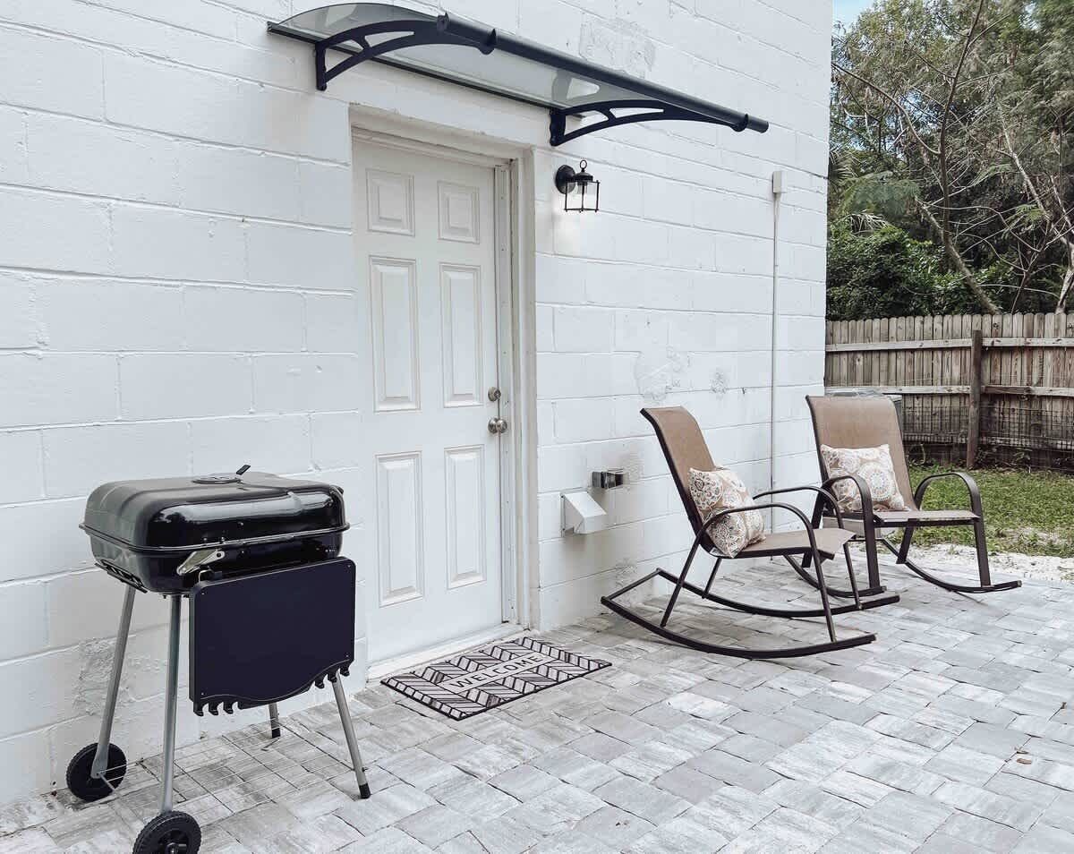 Back Door with Charcoal Grill and Rocking Chairs