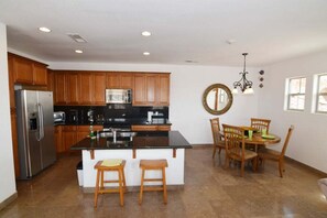 Oven, coffee/tea maker, cookware/dishes/utensils, dining tables