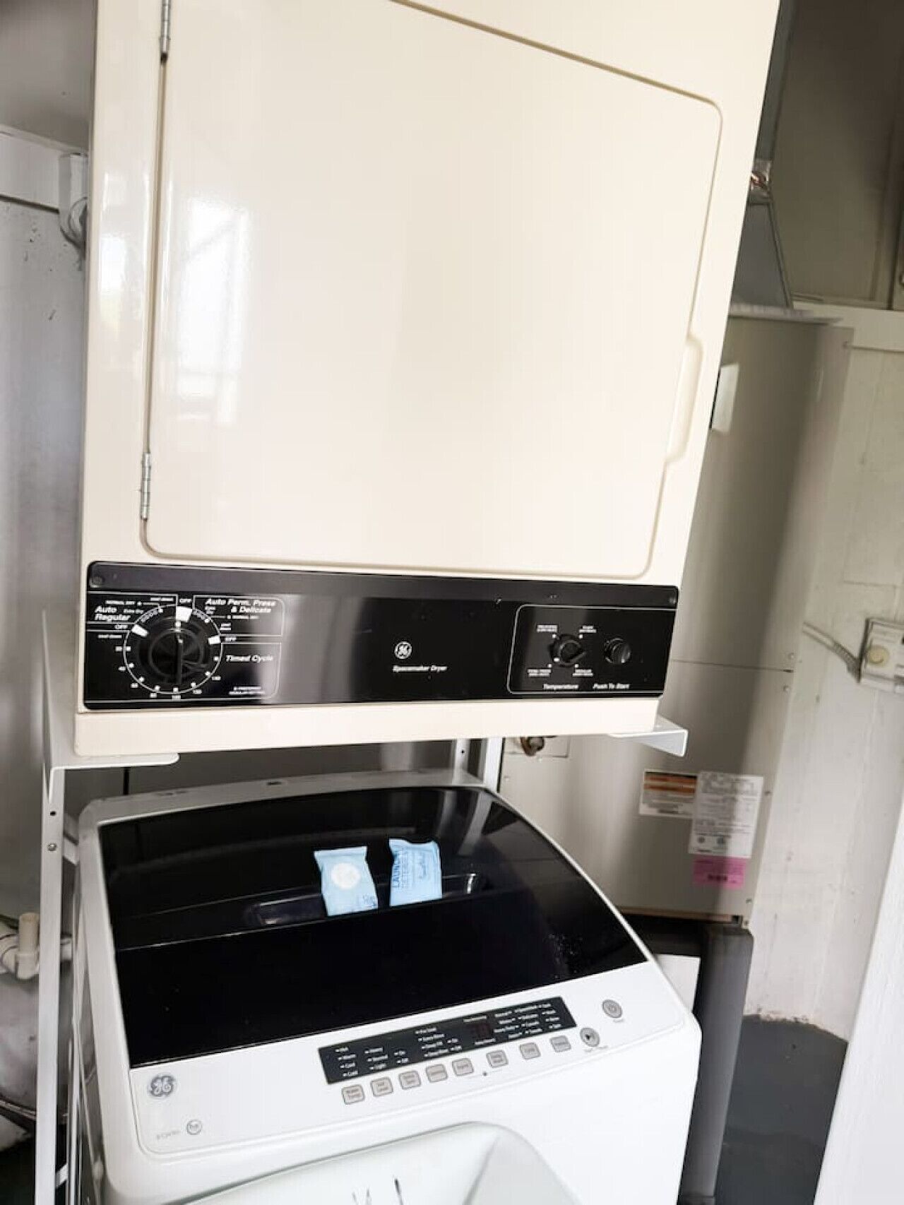 A GE steam iron with a control panel and a transparent water tank.
