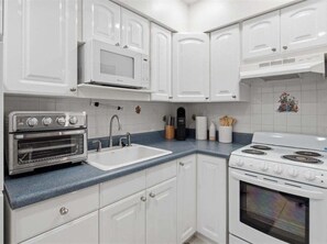Fridge, microwave, oven, stovetop - 1BR Marco Island condo with pool, WiFi, and full kitchen. (Marco Island)