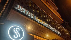 The exterior of the JSTAR Hotel with its illuminated signage and a prominent logo. - JStar Hotel Shinsaibashi (Osaka)