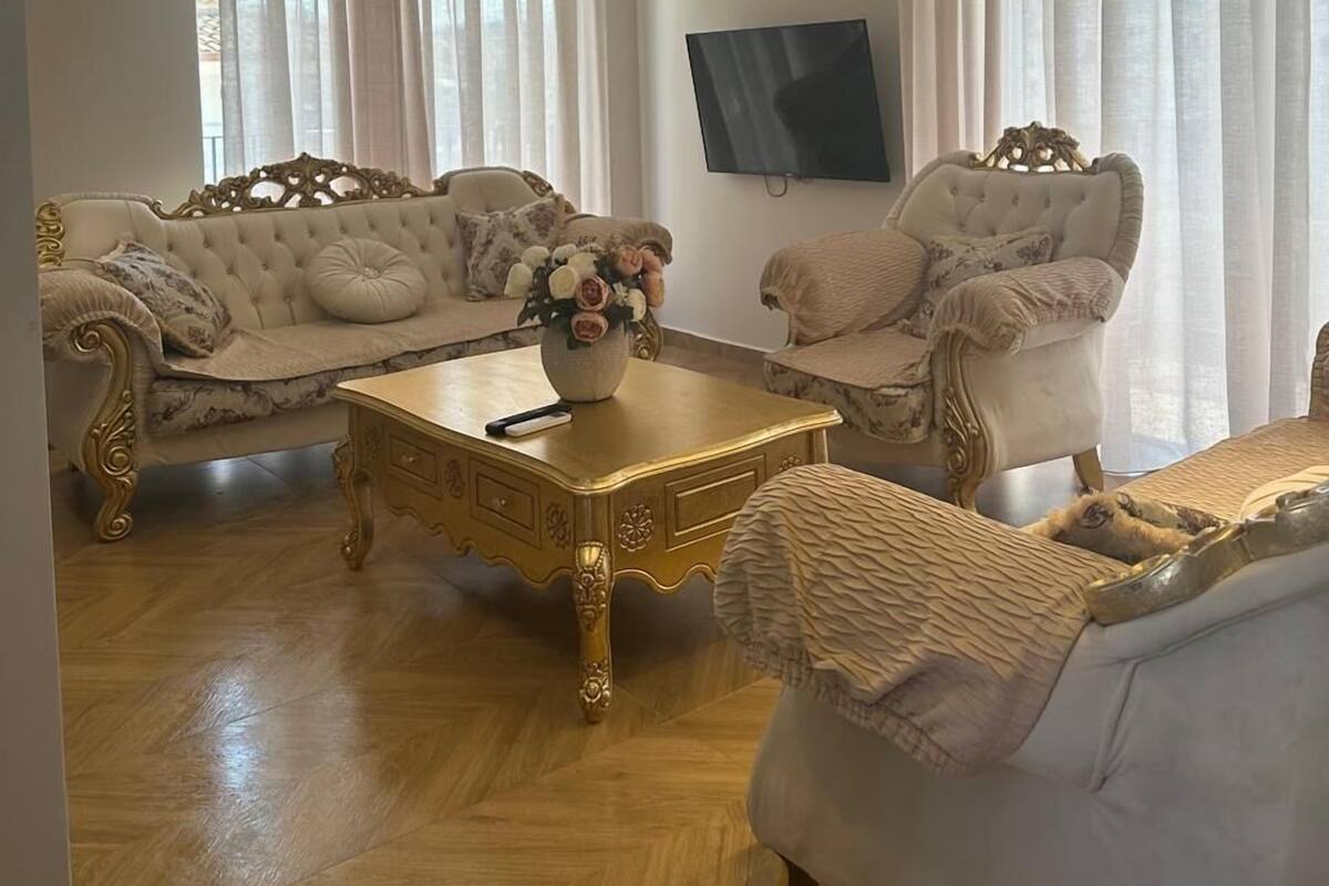 A living room with two sofas, a coffee table, and a television.