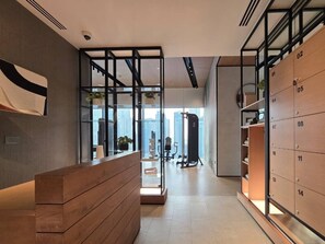 A modern hotel lobby with a reception desk, a glass partition, and a view of the cityscape. - Exclusive Offer · VIDA Marina 2BR · Luxury (Dubai)