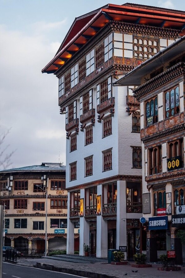 A multi-story building with traditional architectural features, including ornate balconies and patterned facades.